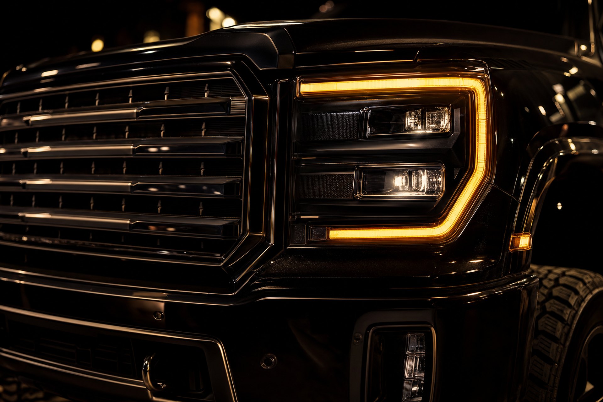 Close-up of a blacked-out truck grille and LED headlight